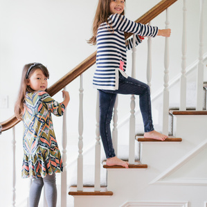 Two sisters play together on stairs