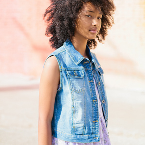 Beautiful girl in fashionable clothes pose in the sun