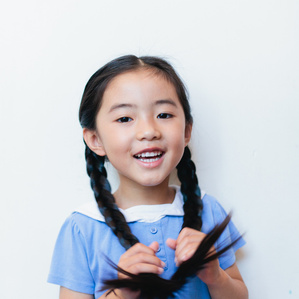 Girl with long braids smiles