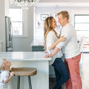 Parents sneak kiss in kitchen while son spies