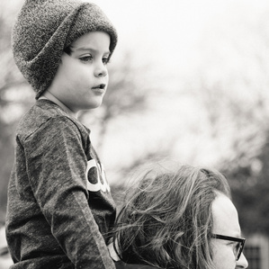 Father holds son on shoulders 