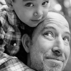 Father and son cuddle closely together