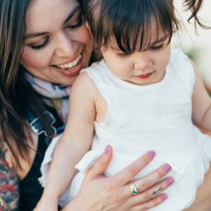 Mother and daughter look down together at flowers