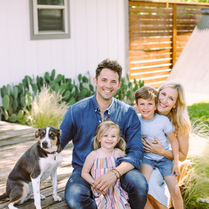 Family of four in backyard with dog