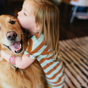 Boy hugs dog 