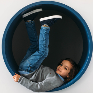 Boy sits inside circle tunnel