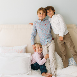 Brothers huddle together on parent's bed