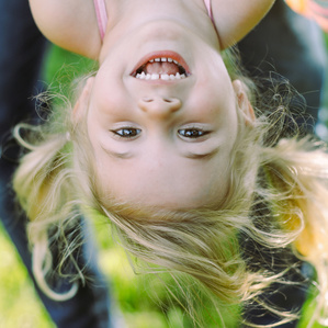Smiling little girl upside down 