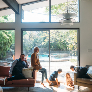 Family sits inside mid century modern home