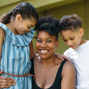 Mother and two kids laughing and smiling together