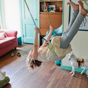 Girl swings in fun bedroom