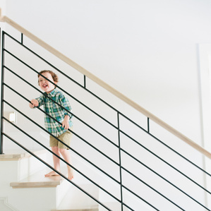 Little boy smiles on staircase