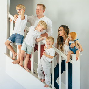 Family on stairs in home being silly