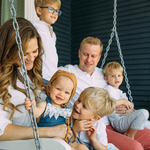 Family of 6 sits on front porch swing together