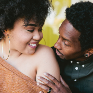 Couple stares at each other next to front door