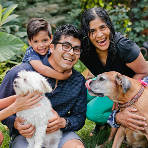Family gathers around dogs in the backyard