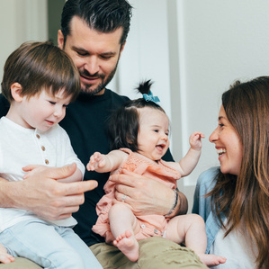 Family sitting together smiling and laughing