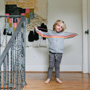 Boy with jumprope stands on stairs