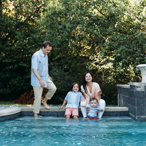 Family hangs out by swimming pool in Texas Summer
