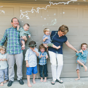 Grandparents stand with grandsons with silly string