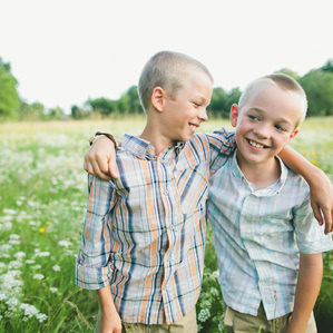 Brothers standing in flower field