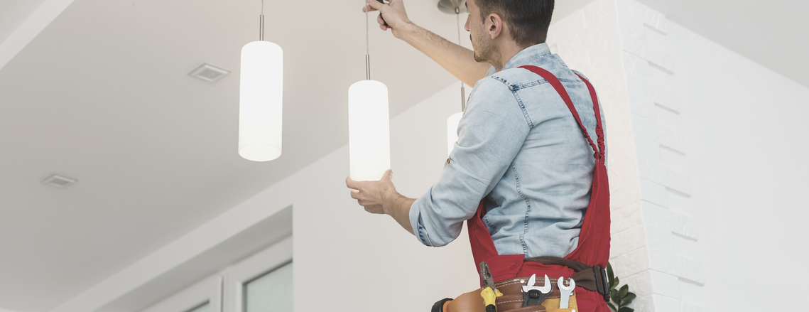 Electrician installing light fixtures.