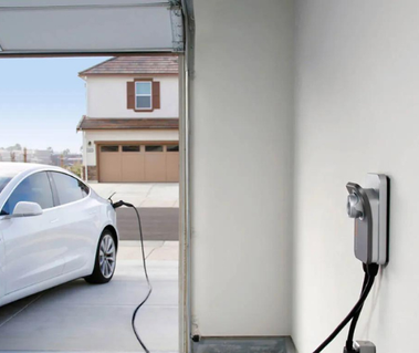 Electric car charging in home garage.