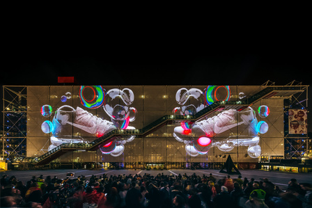 nike sneaker video mapping on the facade of the centre pompidou in front of a crowd at night