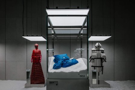 various jacket displays made of mirror and metal lit up from the top set on a snowy floor