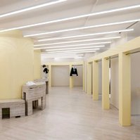 roman travertine floor and furniture with glossy yellow metal structures.