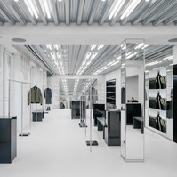 concrete floor and walls with metal and black lacquer pieces of furniture.