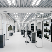 concrete floor and walls with metal and black lacquer pieces of furniture.
