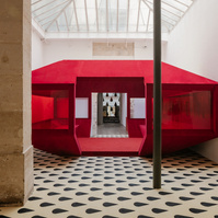 red velvet structure set inside a typical Parisian art gallery interior.