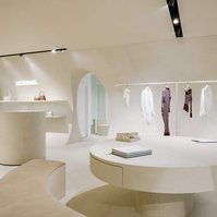 store interior with soft round shapes clad in champagne-coloured limestone