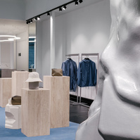 travertine column displays set on a blue carpet. 