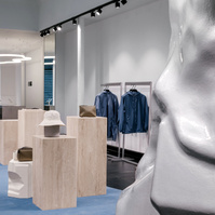 travertine column displays set on a blue carpet. 