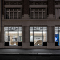 Axel Arigato flagship store in paris, france. designed by Halleroed using travertine for pillars and furniture.