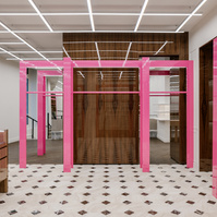 fuschia metallic elements and glossy wood lit by a white neon grid 