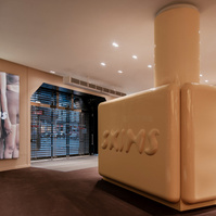 glossy display unit branded with SKIMS logo inside a mall