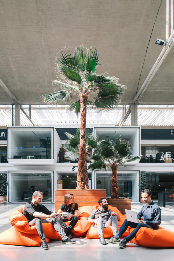 station f, orange, beanbags, team meeting, palm tree, candid shot, people, architecture