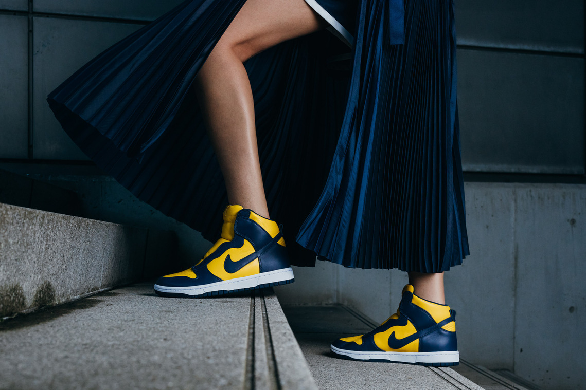 sneakers details, blue leather, yellow leather, blue dress, marble steps, thigh, leg, artificial lighting, nike