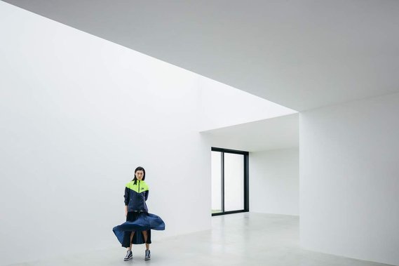 architectural shot, window, white walls, concrete floor, blue dress, movement, sportswear, nike, yellow details, fashion
