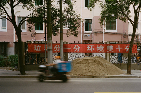 sand, red banner, chinese characters, scooter, pink building, street, china, shanghai
