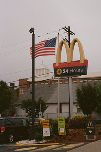 McDonald's sign next to an american flag