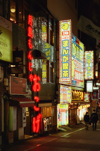 wall of neon signs and advertisements