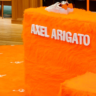 pop-up store display made of orange fur set on an orange carpet