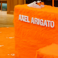 pop-up store display made of orange fur set on an orange carpet