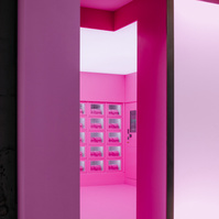 pink vending machines shown through an open door.