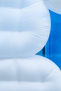 detail of an white plastic inflatable display in front of a blue window