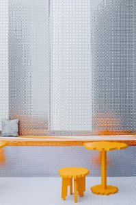 orange low res furniture set into a pixelated metal environment